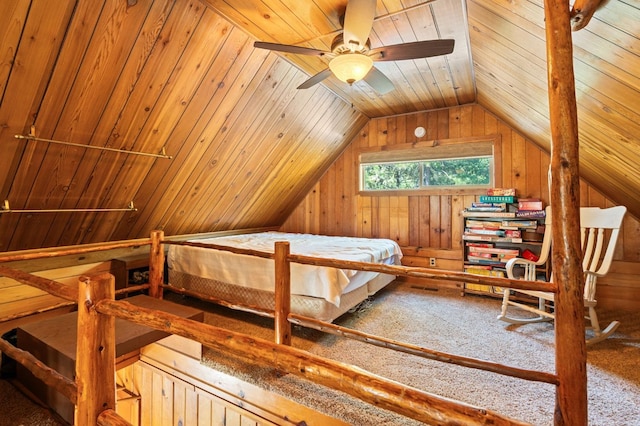 bedroom featuring vaulted ceiling, carpet, wood ceiling, and wood walls