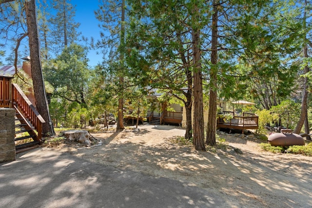 view of yard with a wooden deck