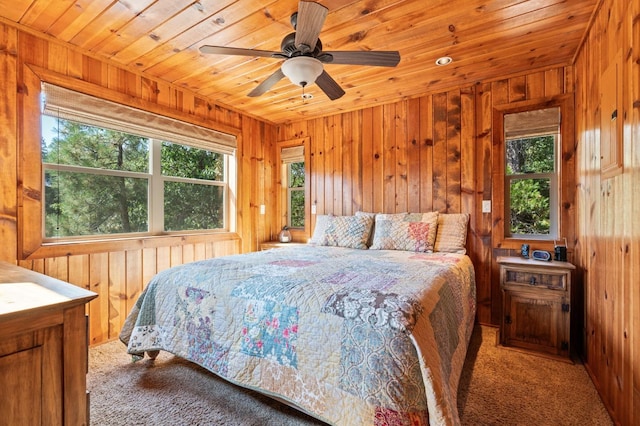 bedroom with light carpet, wooden ceiling, and wooden walls