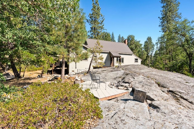 rear view of property featuring a deck