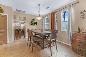 tiled dining room featuring a healthy amount of sunlight