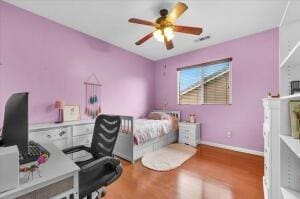 bedroom featuring hardwood / wood-style flooring and ceiling fan