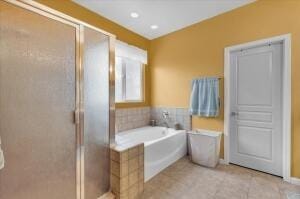 bathroom with tile patterned flooring and independent shower and bath