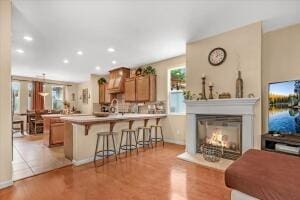 kitchen featuring light wood-type flooring, kitchen peninsula, and a breakfast bar area