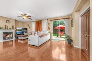 living room featuring ceiling fan and wood-type flooring