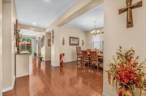 dining space featuring dark hardwood / wood-style flooring and an inviting chandelier