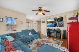 living room featuring wood-type flooring and ceiling fan