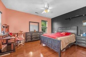 bedroom with hardwood / wood-style flooring and ceiling fan