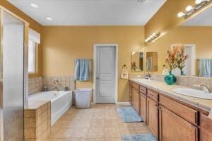 bathroom featuring a washtub, vanity, and tile patterned flooring