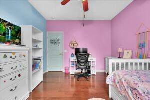 bedroom featuring ceiling fan and dark wood-type flooring