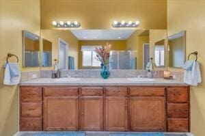 bathroom featuring vanity and a shower