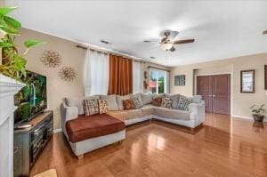 living room featuring hardwood / wood-style flooring and ceiling fan