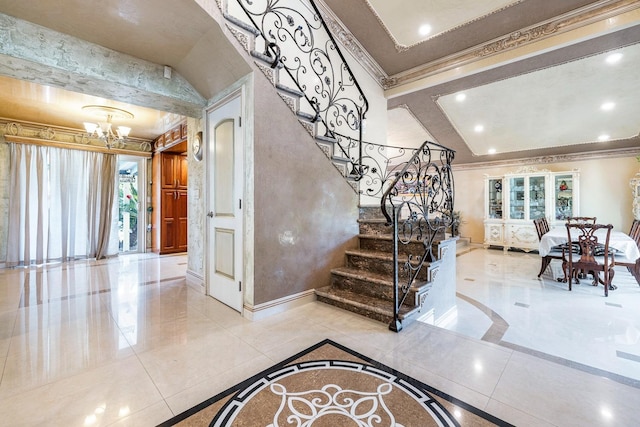 stairs with crown molding and a chandelier