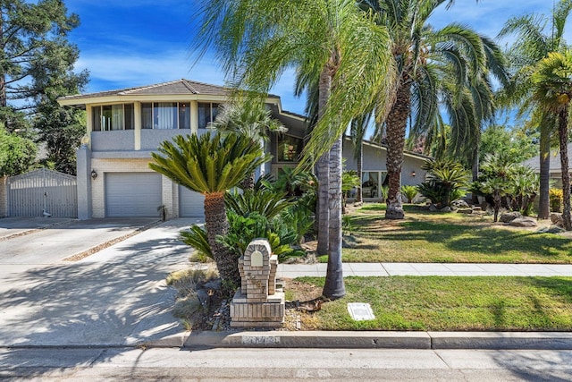 view of front of home with a garage and a front lawn