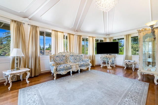 sunroom / solarium featuring lofted ceiling with beams and a chandelier