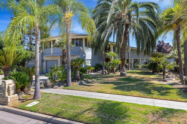 view of front facade with a garage and a front lawn