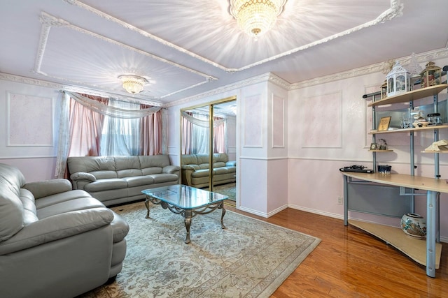 living room with hardwood / wood-style floors and a notable chandelier