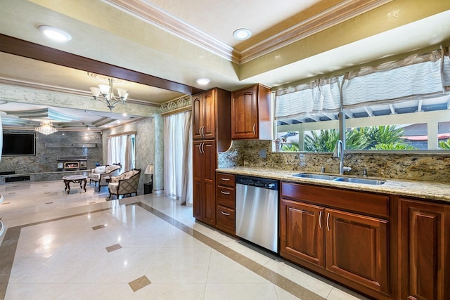 kitchen with sink, ornamental molding, a tray ceiling, dishwasher, and light stone countertops