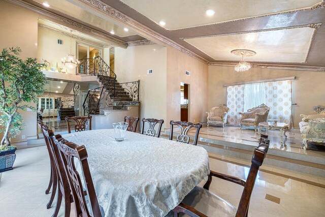 dining room featuring lofted ceiling, crown molding, and a chandelier