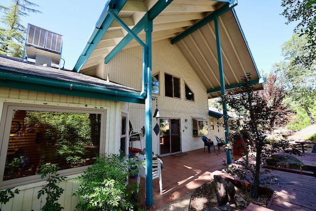 rear view of house featuring a wooden deck