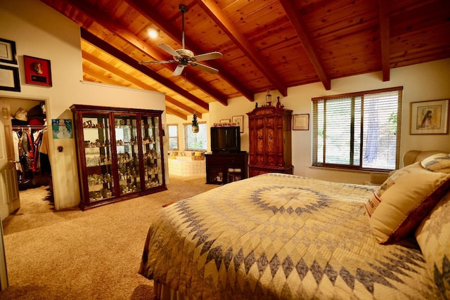 carpeted bedroom featuring a walk in closet, lofted ceiling with beams, and wooden ceiling