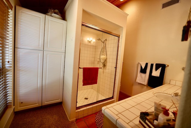 bathroom with vanity and an enclosed shower