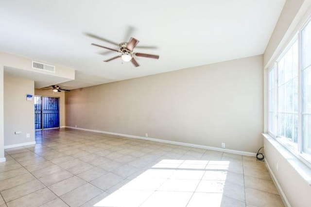 unfurnished room featuring light tile patterned floors and ceiling fan