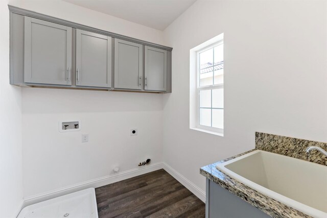 laundry area with cabinets, washer hookup, hookup for an electric dryer, dark wood-type flooring, and hookup for a gas dryer