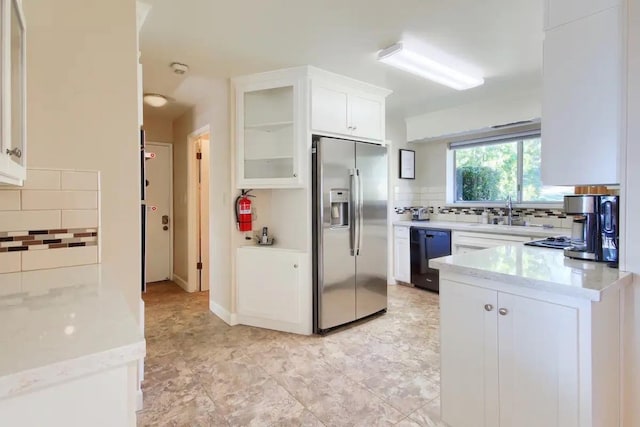 kitchen featuring stainless steel refrigerator with ice dispenser, light tile patterned floors, dishwasher, tasteful backsplash, and white cabinetry