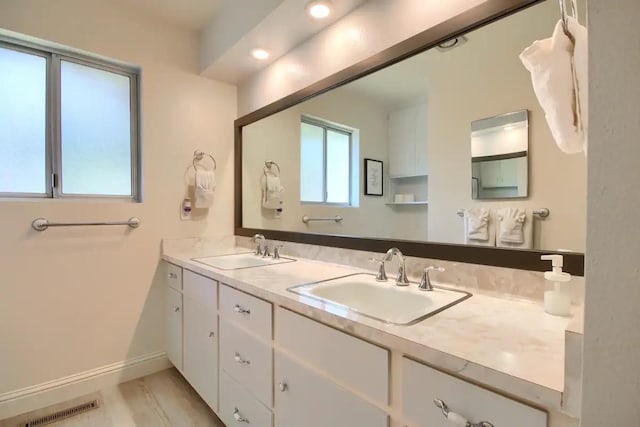 bathroom featuring dual bowl vanity