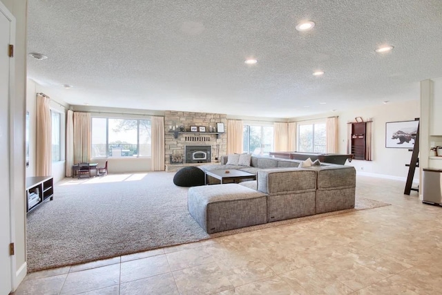 carpeted living room with a textured ceiling and a fireplace