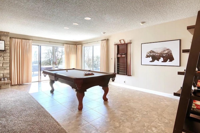 recreation room with light tile patterned floors, billiards, and a textured ceiling