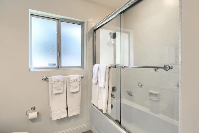 bathroom featuring shower / bath combination with glass door