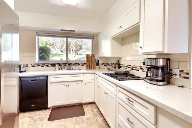 kitchen featuring tasteful backsplash, light tile patterned floors, white cabinets, black appliances, and sink