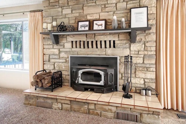 interior details featuring a fireplace, a wood stove, and carpet floors