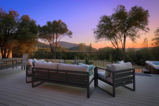 deck at dusk with an outdoor living space