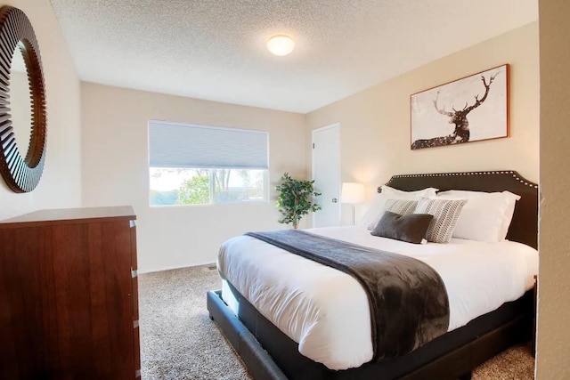 carpeted bedroom featuring a textured ceiling