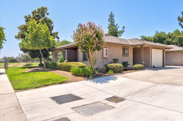 view of front facade with a front yard and a garage