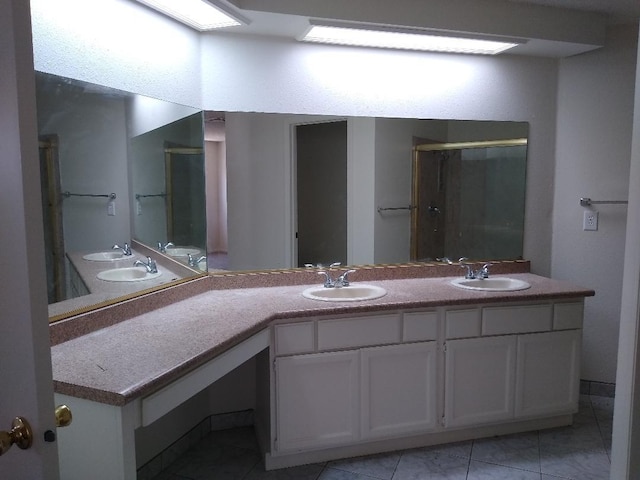 bathroom featuring dual bowl vanity and tile patterned flooring