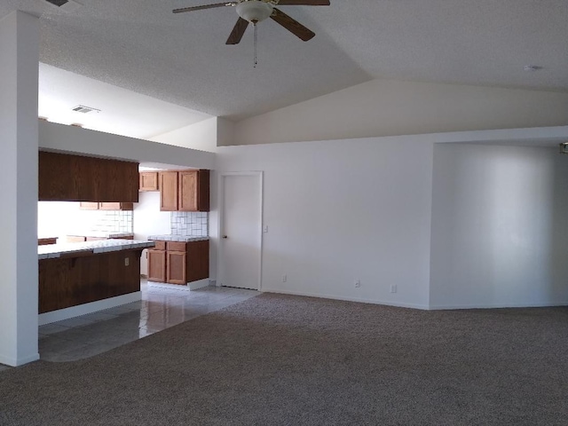 unfurnished living room with lofted ceiling, light tile patterned floors, and ceiling fan