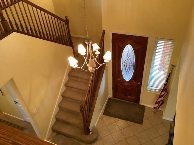 tiled foyer with a notable chandelier