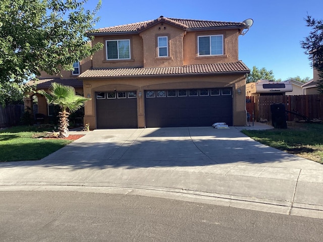 mediterranean / spanish home featuring a garage