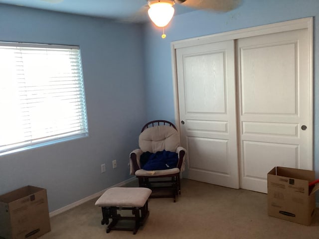 living area with light carpet and a healthy amount of sunlight