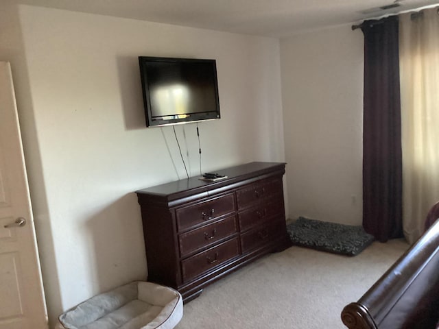 sitting room featuring light colored carpet