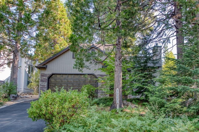 view of side of home with stone siding