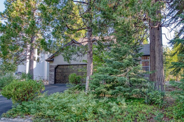 exterior space featuring aphalt driveway and an attached garage