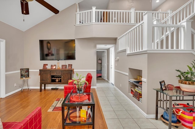 living room with ceiling fan, high vaulted ceiling, and hardwood / wood-style floors