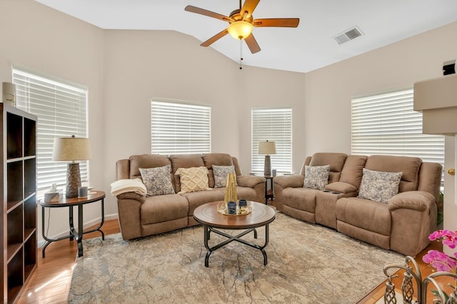 living room featuring lofted ceiling, light hardwood / wood-style flooring, and ceiling fan