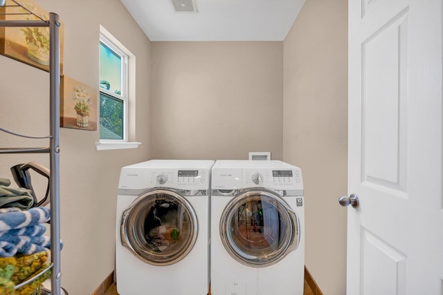 washroom with independent washer and dryer