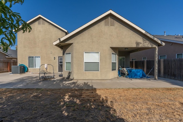 rear view of property with a patio area and central AC unit